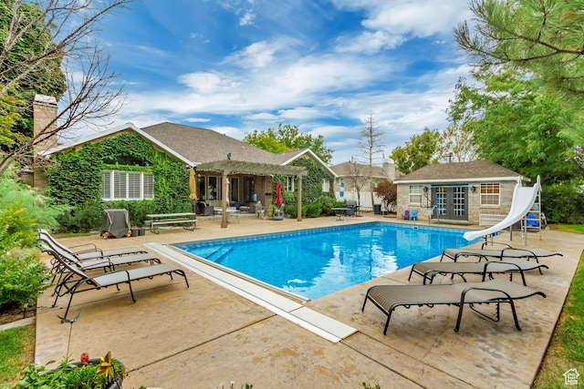 2768 W Country Classic Dr, Bluffdale, UT 84065 - outdoor pool with a pergola, a water slide, an outdoor structure, a patio, and a storage structure