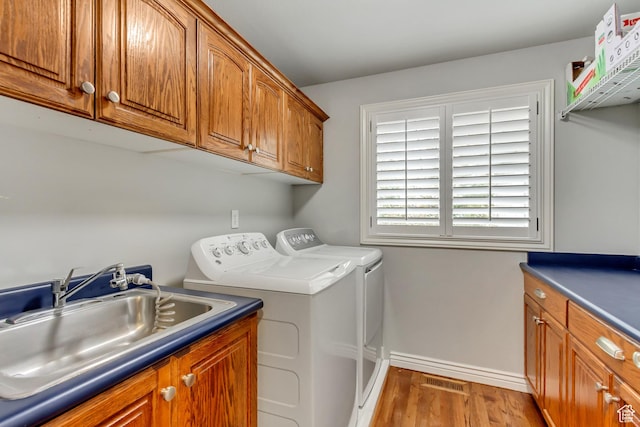 2768 W Country Classic Dr, Bluffdale, UT 84065 - washroom with wood finished floors, a sink, washer and dryer, baseboards, and cabinet space