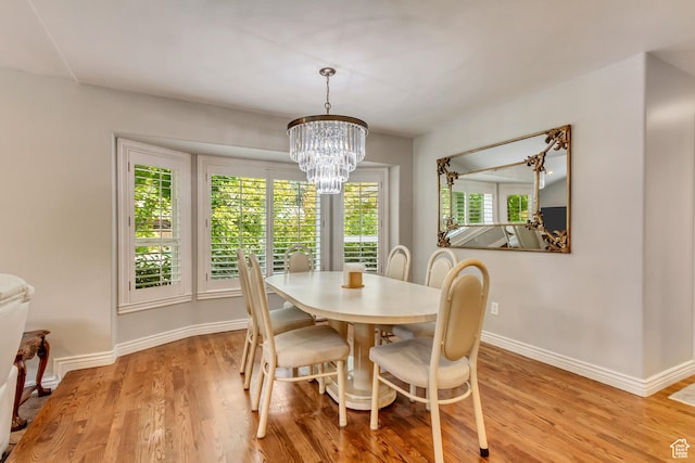 2768 W Country Classic Dr, Bluffdale, UT 84065 - dining area with a chandelier, light wood-style flooring, and baseboards
