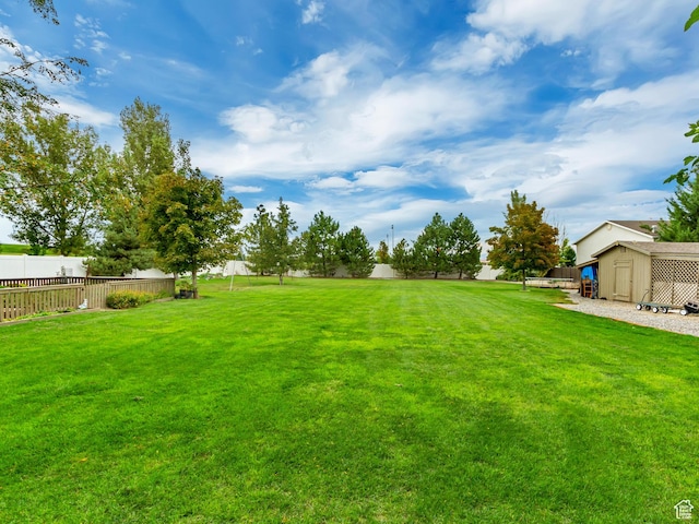 2768 W Country Classic Dr, Bluffdale, UT 84065 - view of yard featuring an outdoor structure, fence, and a storage unit
