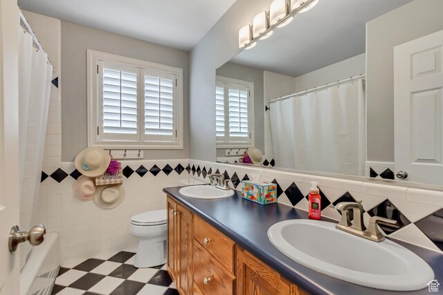 2768 W Country Classic Dr, Bluffdale, UT 84065 - bathroom featuring a sink, tile walls, a wainscoted wall, and toilet