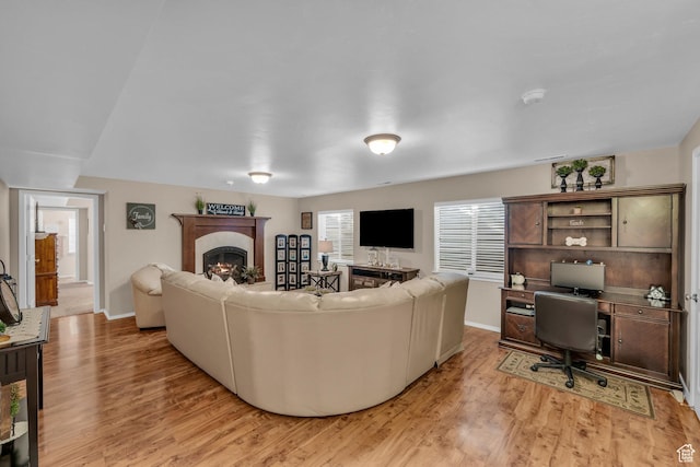 2218 W 2575 N, Cedar City, UT 84721 - living room with a lit fireplace, light wood finished floors, and baseboards