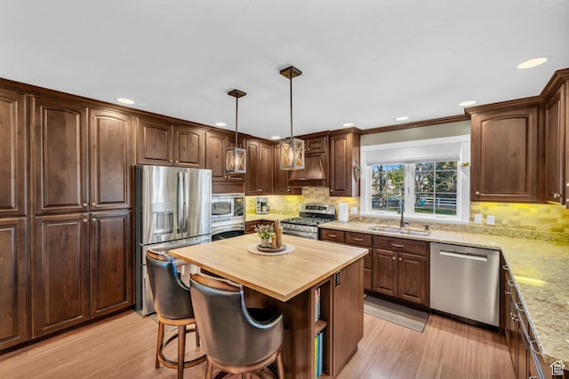 2218 W 2575 N, Cedar City, UT 84721 - kitchen with light wood finished floors, a kitchen island, appliances with stainless steel finishes, and a sink