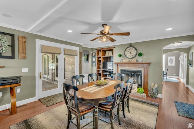 2218 W 2575 N, Cedar City, UT 84721 - dining room with light wood finished floors, baseboards, arched walkways, and a glass covered fireplace