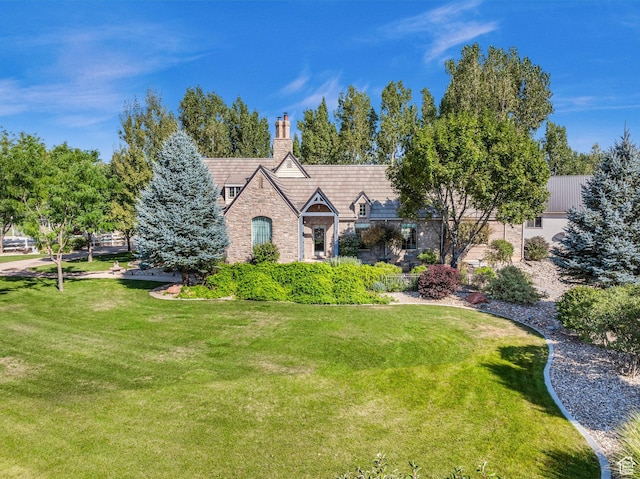 2218 W 2575 N, Cedar City, UT 84721 - tudor home featuring stone siding, a chimney, and a front lawn