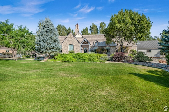 2218 W 2575 N, Cedar City, UT 84721 - tudor home featuring stone siding, a chimney, and a front lawn