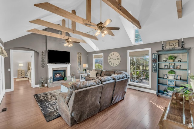 2218 W 2575 N, Cedar City, UT 84721 - living room with visible vents, arched walkways, a glass covered fireplace, wood finished floors, and beam ceiling