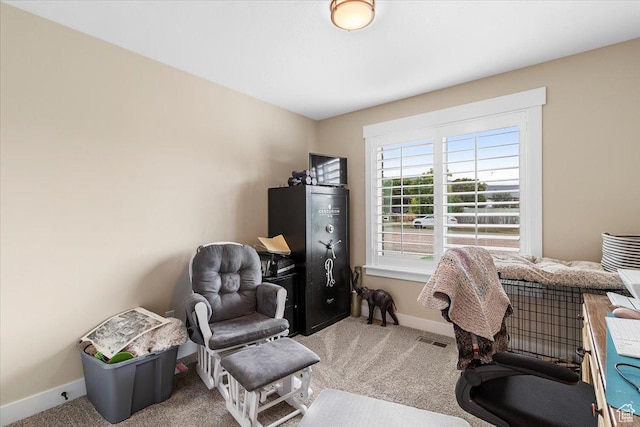office space featuring baseboards, visible vents, and carpet