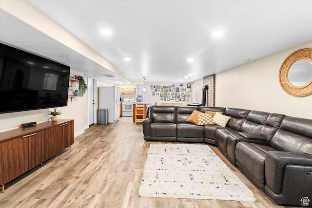 living area featuring recessed lighting and light wood-style floors