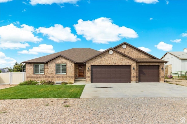 single story home with fence, a garage, concrete driveway, brick siding, and a front lawn