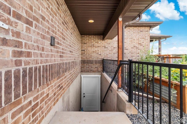 view of exterior entry with brick siding