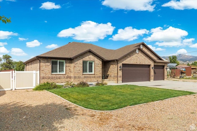 single story home featuring fence, driveway, a front yard, brick siding, and a garage