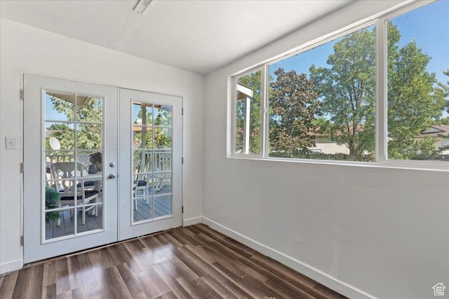 doorway with french doors, baseboards, and dark wood-type flooring