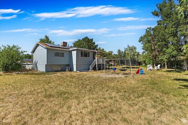 view of yard featuring central air condition unit and a playground