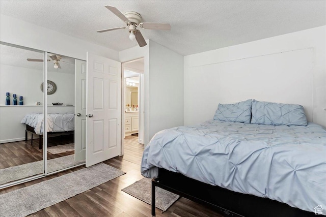 bedroom with a closet, a textured ceiling, a ceiling fan, and wood finished floors