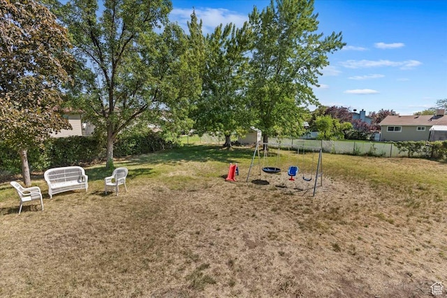 view of yard featuring a playground and fence
