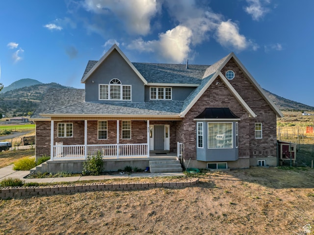view of front facade with covered porch and a mountain view