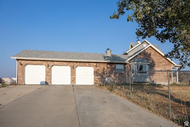 ranch-style home featuring a garage