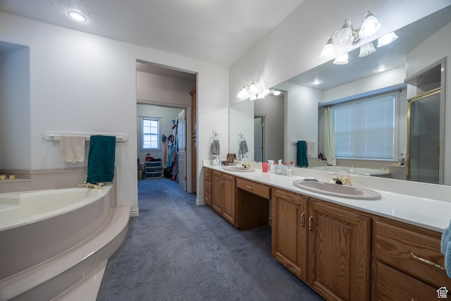 bathroom featuring vanity, a textured ceiling, and shower with separate bathtub