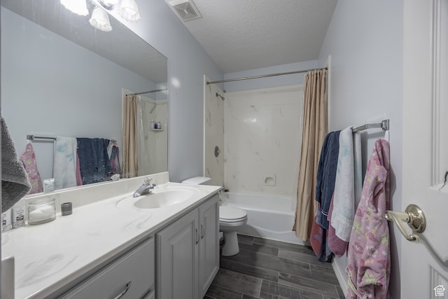 full bathroom with a textured ceiling, vanity, shower / tub combo, toilet, and hardwood / wood-style flooring