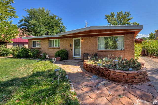 343 S Tusher St, Moab, UT 84532 - view of front of home with a patio and a front lawn