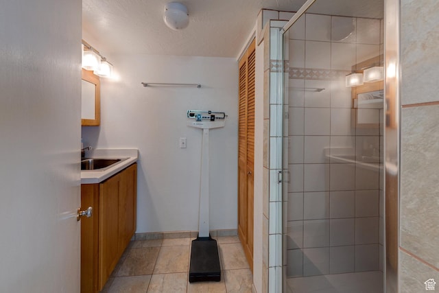 343 S Tusher St, Moab, UT 84532 - full bath featuring a stall shower, vanity, baseboards, and tile patterned flooring