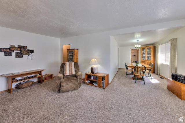 343 S Tusher St, Moab, UT 84532 - living area featuring carpet floors, an inviting chandelier, visible vents, and a textured ceiling