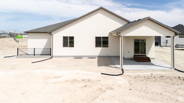 678 S Todd Ct, Grantsville, UT 84029 - back of house featuring entry steps, a patio, and stucco siding