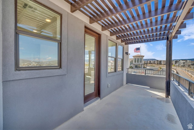 view of patio / terrace with a balcony and a pergola