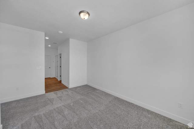 carpeted empty room with recessed lighting and baseboards