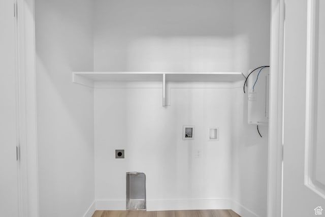 washroom with baseboards, wood finished floors, hookup for an electric dryer, and hookup for a washing machine