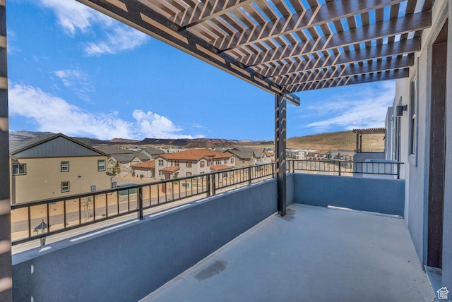 balcony featuring a residential view and a pergola