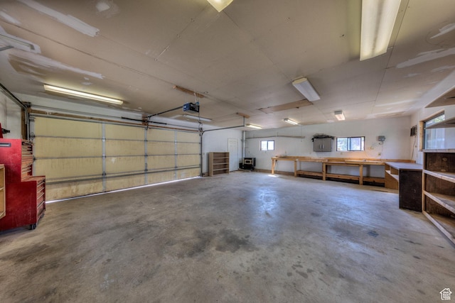 garage featuring a garage door opener and a workshop area