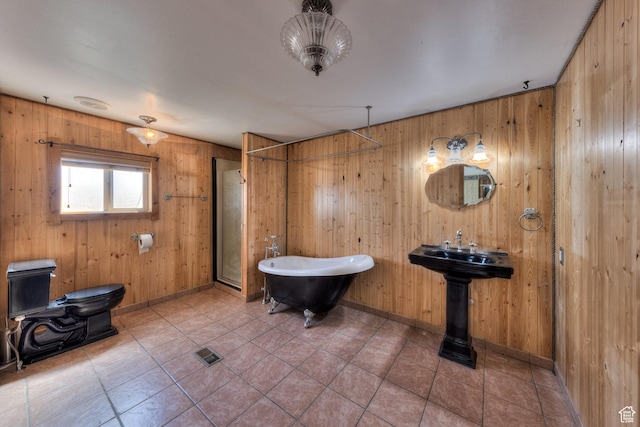 bathroom featuring a soaking tub, a shower stall, visible vents, tile patterned floors, and baseboards