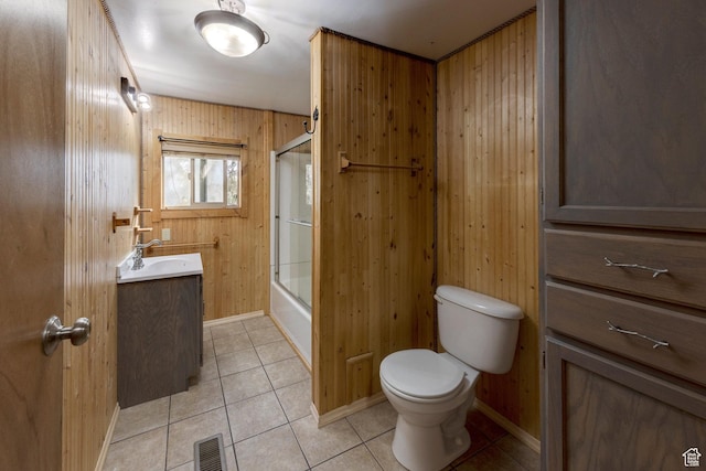 full bath featuring vanity, tile patterned flooring, toilet, wood walls, and visible vents