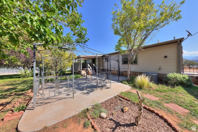 rear view of house with fence and a patio