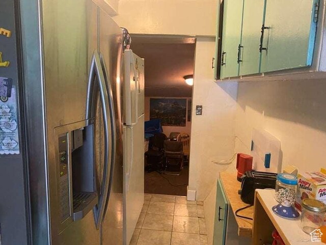 215 W 200 S, Duchesne, UT 84021 - kitchen featuring light tile patterned flooring, green cabinets, stainless steel fridge with ice dispenser, and light countertops
