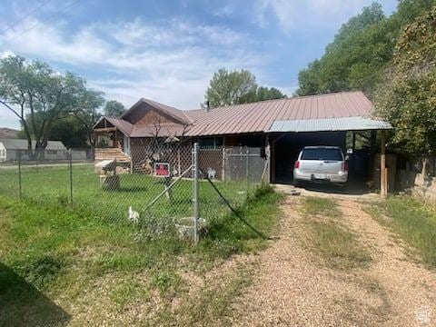 215 W 200 S, Duchesne, UT 84021 - view of front facade with metal roof, driveway, and fence
