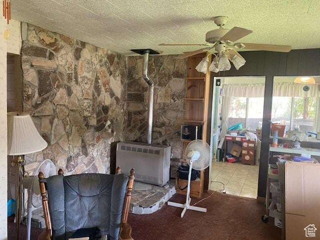 215 W 200 S, Duchesne, UT 84021 - carpeted living room with a wood stove, ceiling fan, and heating unit