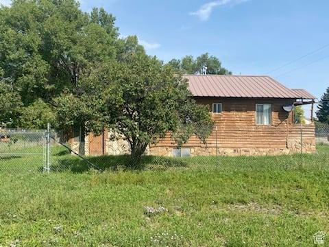 215 W 200 S, Duchesne, UT 84021 - exterior space with fence, metal roof, and a lawn