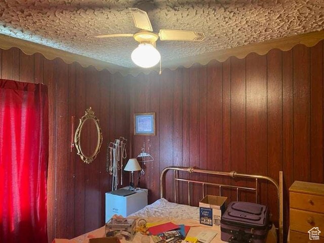 215 W 200 S, Duchesne, UT 84021 - bedroom with a textured ceiling, wooden walls, and ceiling fan