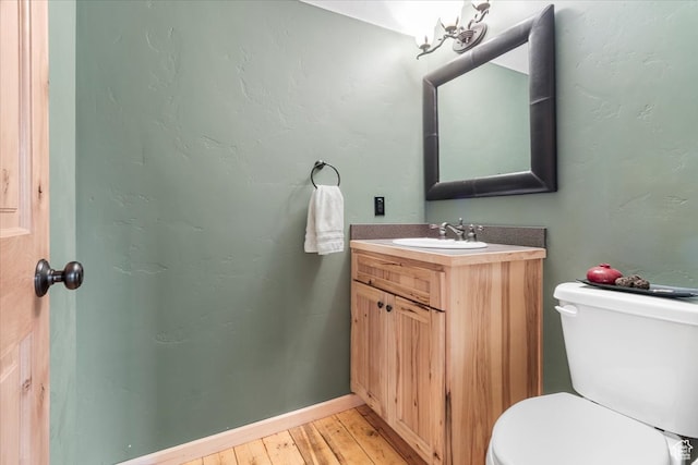 14775 N 12565 E 66&67, Mount Pleasant, UT 84647 - half bathroom featuring vanity, toilet, baseboards, and wood-type flooring