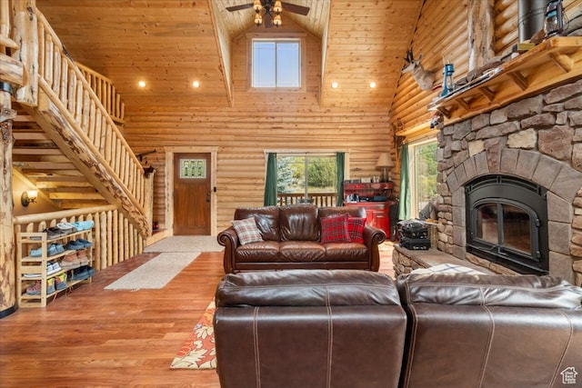 14775 N 12565 E 66&67, Mount Pleasant, UT 84647 - living area with wood finished floors, high vaulted ceiling, a fireplace, ceiling fan, and rustic walls