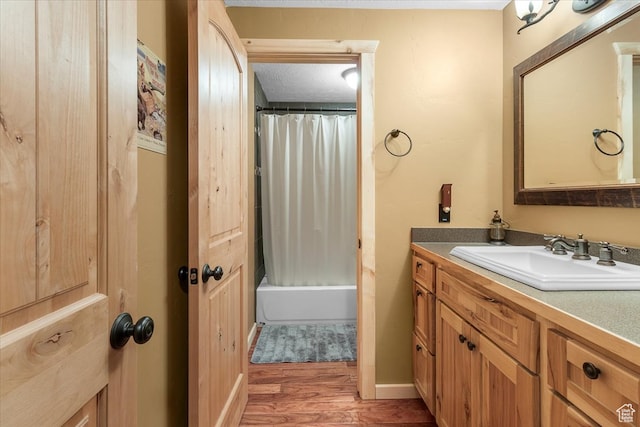 14775 N 12565 E 66&67, Mount Pleasant, UT 84647 - bathroom featuring vanity, wood finished floors, shower / bath combo with shower curtain, and baseboards
