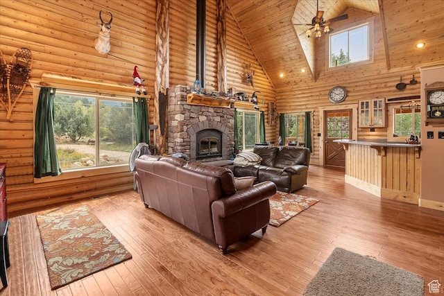 14775 N 12565 E 66&67, Mount Pleasant, UT 84647 - living room with ceiling fan, log walls, hardwood / wood-style floors, a stone fireplace, and high vaulted ceiling