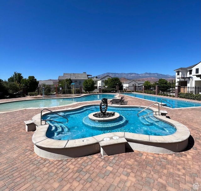 pool featuring a mountain view and fence
