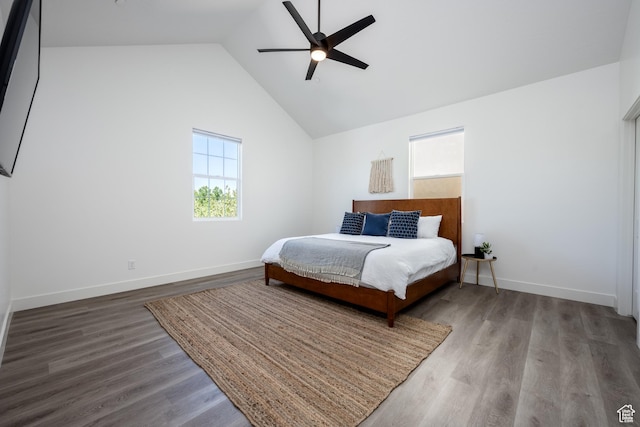 bedroom with baseboards, wood finished floors, ceiling fan, and lofted ceiling