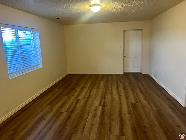 14112 S Senior Band Rd, Draper, UT 84020 - unfurnished room featuring dark wood-style floors, baseboards, and a textured ceiling