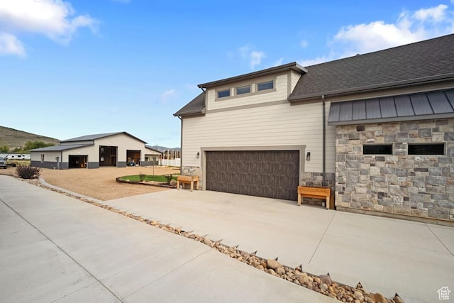 1806 S Summit Haven Dr Unit 1, Francis, UT 84036 - view of property exterior with an attached garage, stone siding, concrete driveway, and a shingled roof