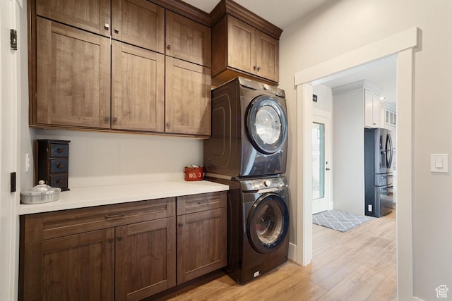 1806 S Summit Haven Dr Unit 1, Francis, UT 84036 - laundry area with cabinet space, stacked washer / dryer, and light wood-style floors